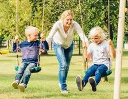 playset with mum pushing kids on swing