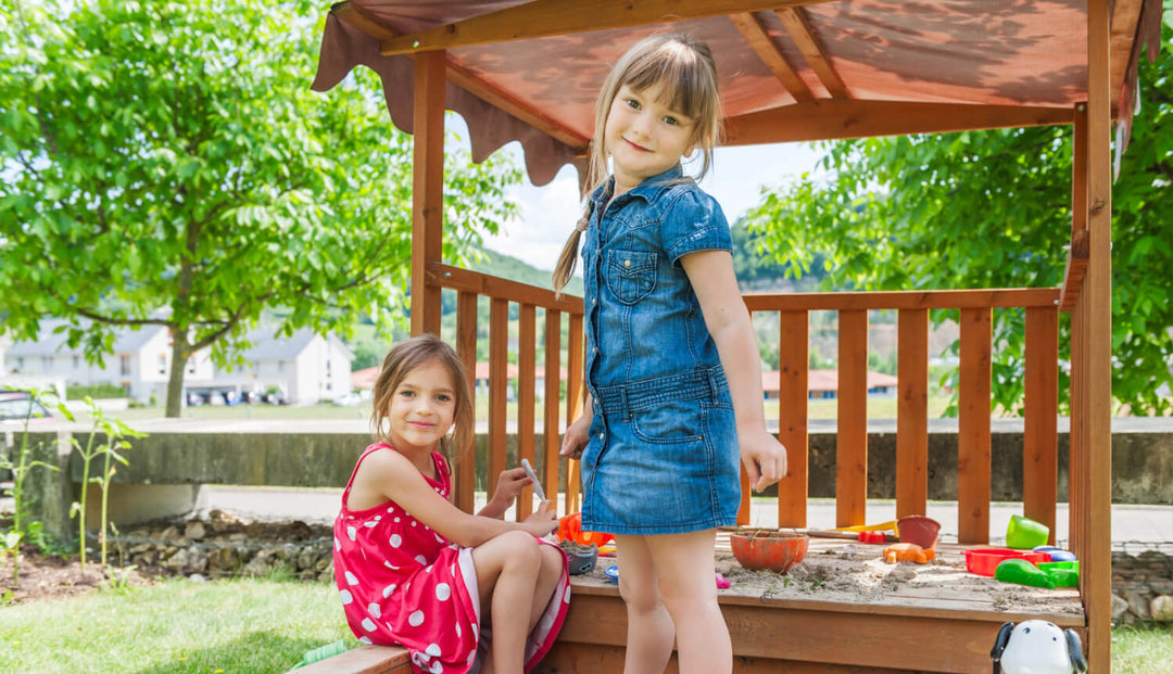 2 kids playing in sandpit during spring