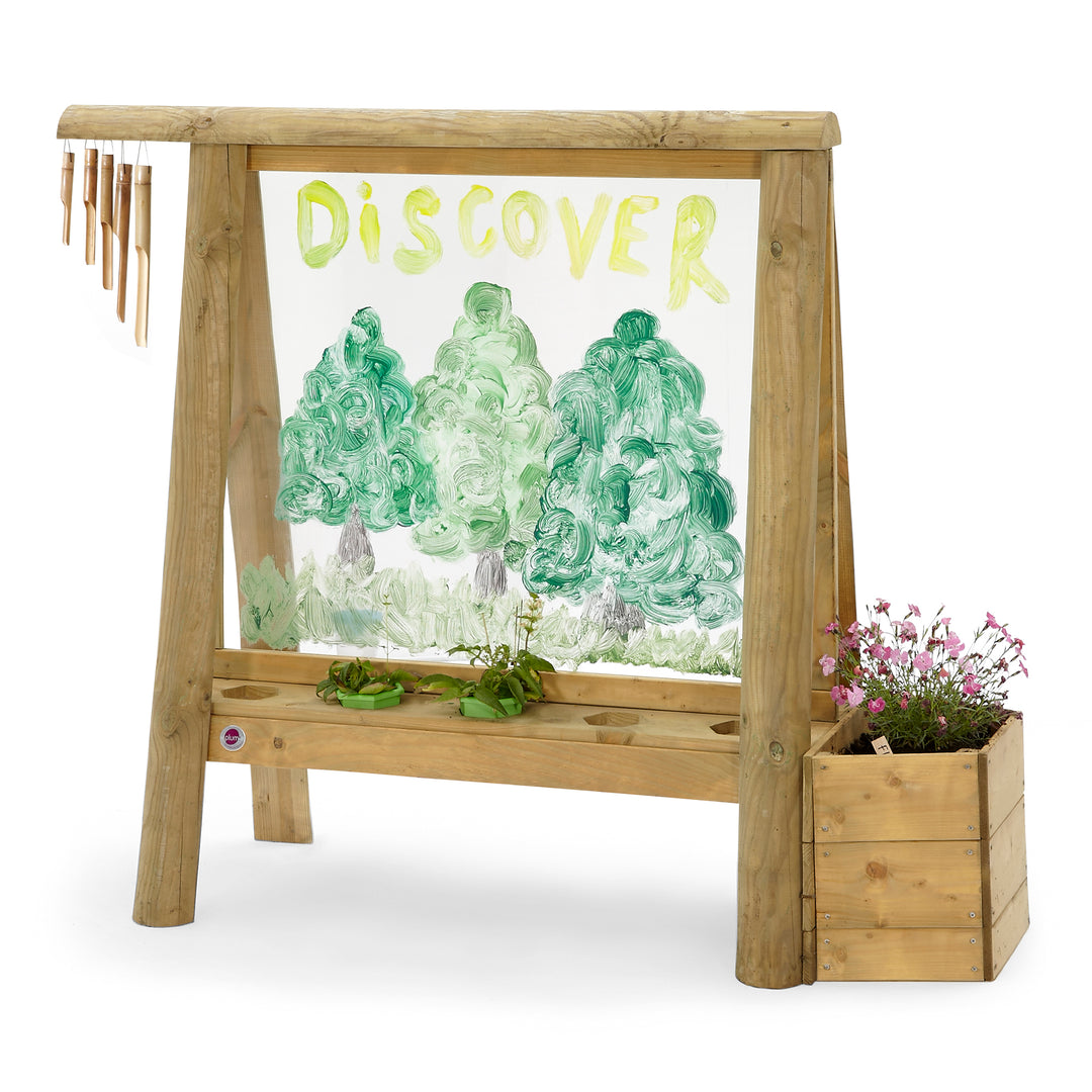 Kids painting easel made from sustainable timber with garden and wood chimes for sensory play in the backyard. Made by Plum Play